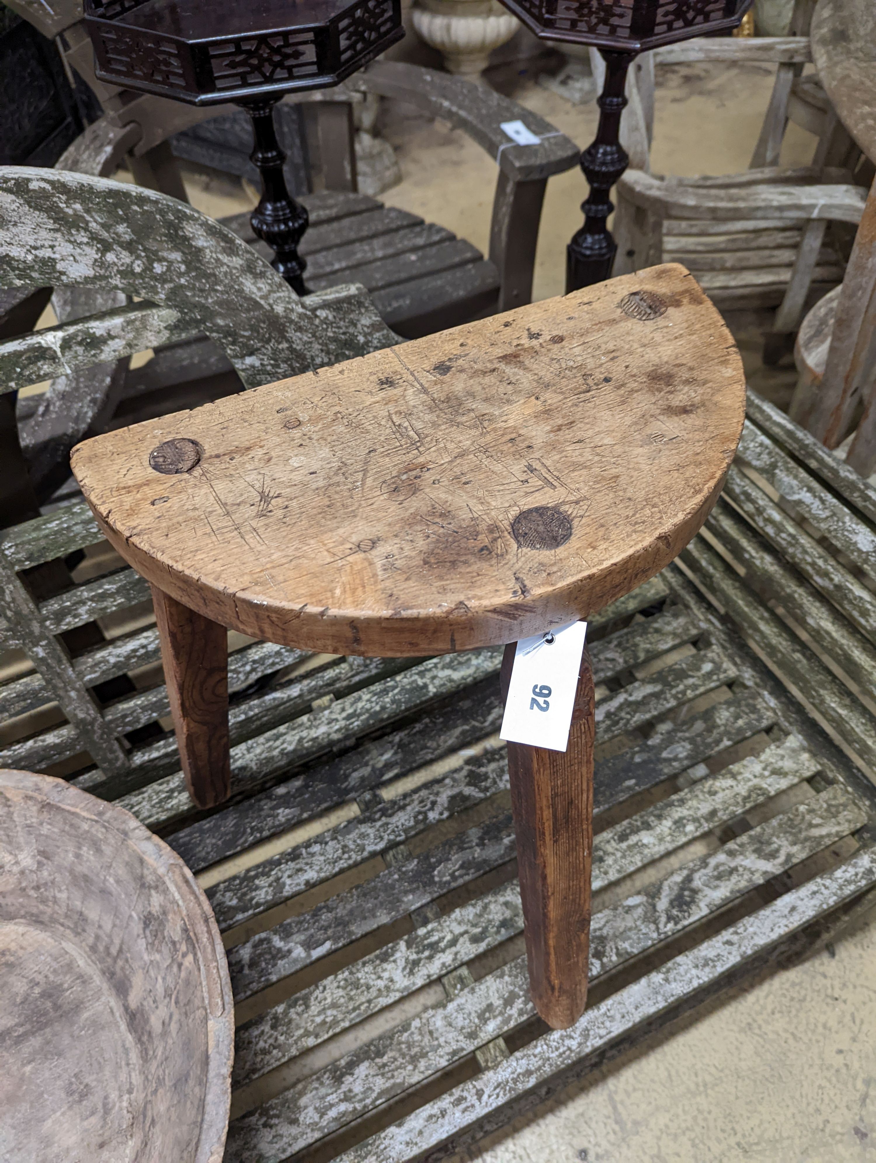 A provincial elm and fruitwood D shaped stool together with a circular iron mounted mazer.